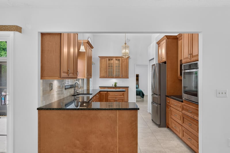 Kitchen island with pendant lighting at 12810 Swamp Owl Ln