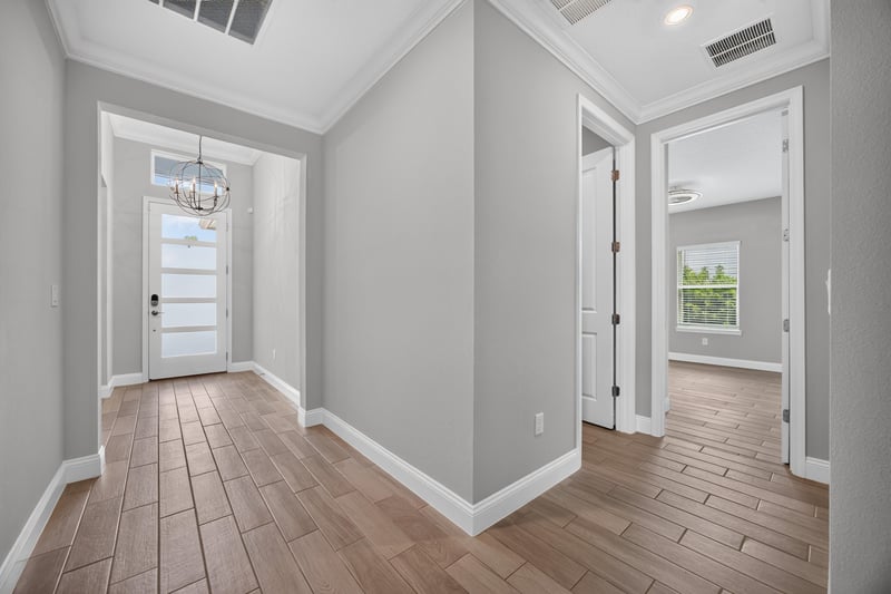 Entry foyer with wood-look tile floors and a lantern chandelier at 91 Tilloo Ct, St. Johns, FL