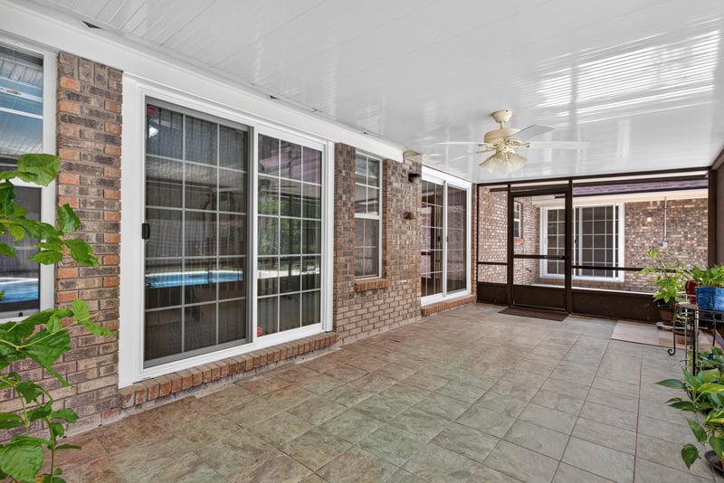 Lanai with sliding doors and ceiling fan at 12810 Swamp Owl Ln