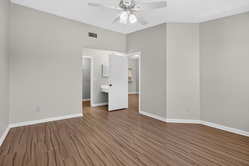 Bedroom with ceiling fan and doorway at 8010 International Village Dr, Jacksonville, FL 32277