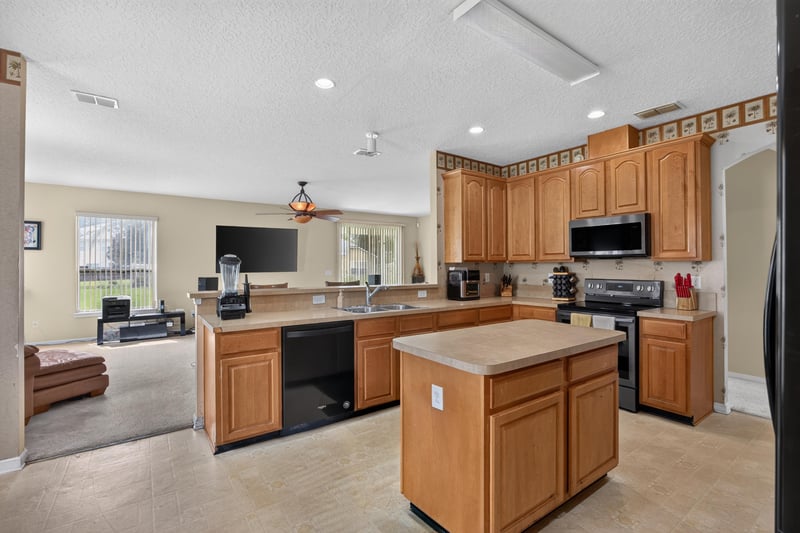 Kitchen open to the family room at 2875 Pebblewood Ln, Orange Park, FL 32065