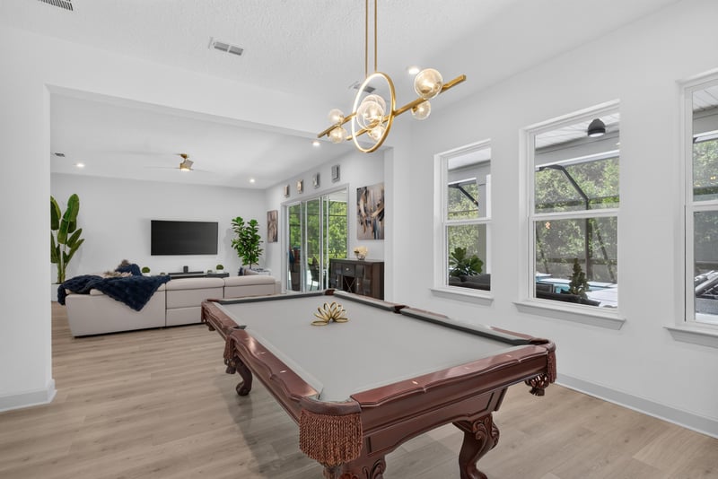 Game room with pool table and bright windows at 785 Back Creek Dr, St. Augustine, FL 32092