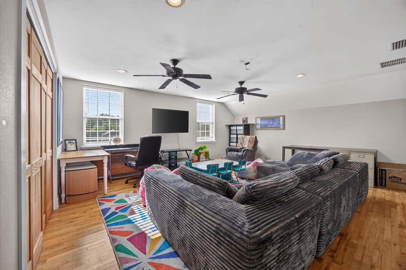 Bonus room furnished with sectional sofa and television at 1735 Hagans Ridge Ct