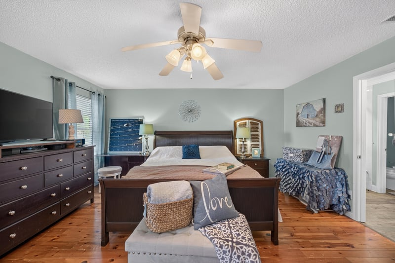 Primary bedroom with bed and nightstands at 4556 Shaky Leaf Ln N, Jacksonville, FL 32224