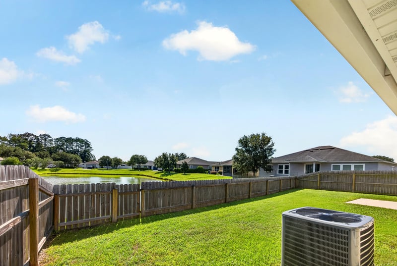 Backyard with wood fence and open field at 7545 Lirope St, Jacksonville, FL 32244
