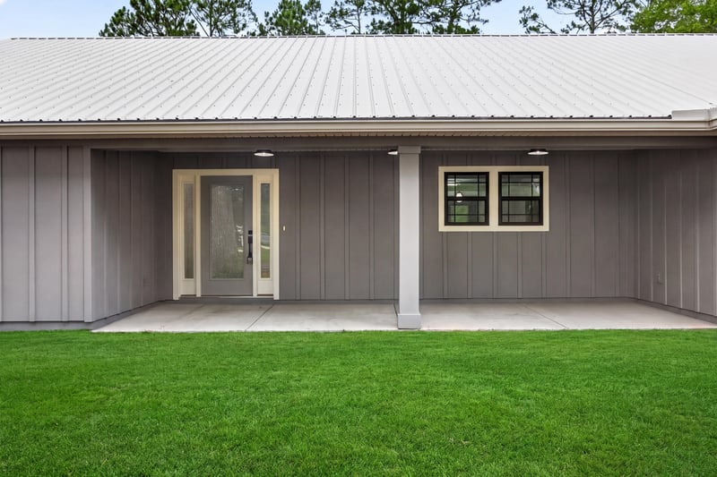 Covered breezeway at the garage with board and batten siding at 4800 Acacia St, Middleburg, FL 32068
