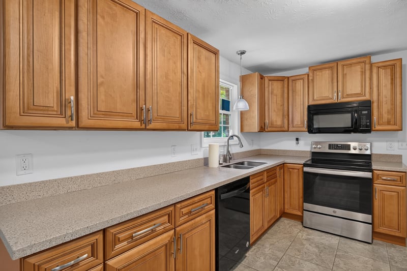 Kitchen with microwave and black range at 1847 Grove Park Dr, Orange Park, FL