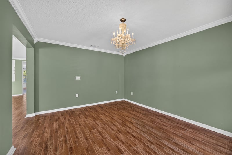 Empty room with green walls and hardwood floor at 2282 Justin Lake Dr, Jacksonville, FL