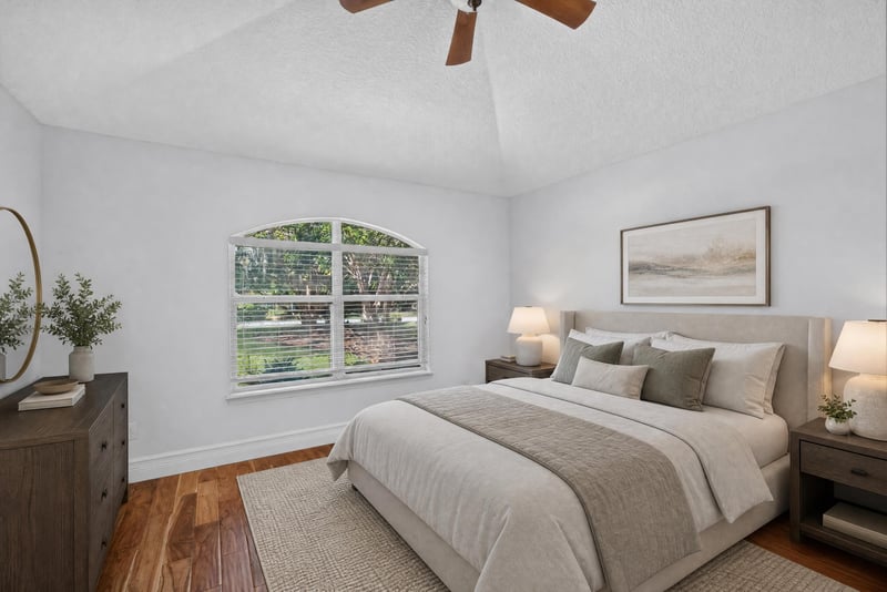 Secondary bedroom staged with bed and lamps at 11675 Magnolia Estates Rd, Jacksonville, FL 32223