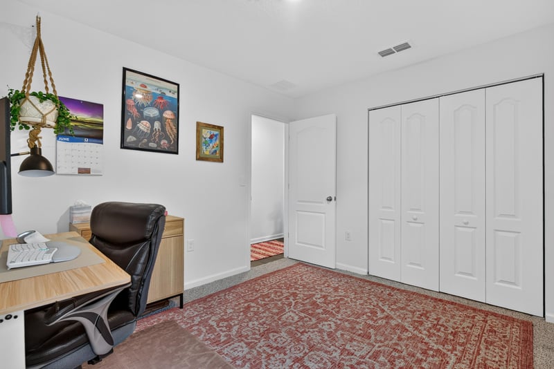 Bedroom with closet doors and area rug at 4276 Quaking St, Jacksonville, FL 32218