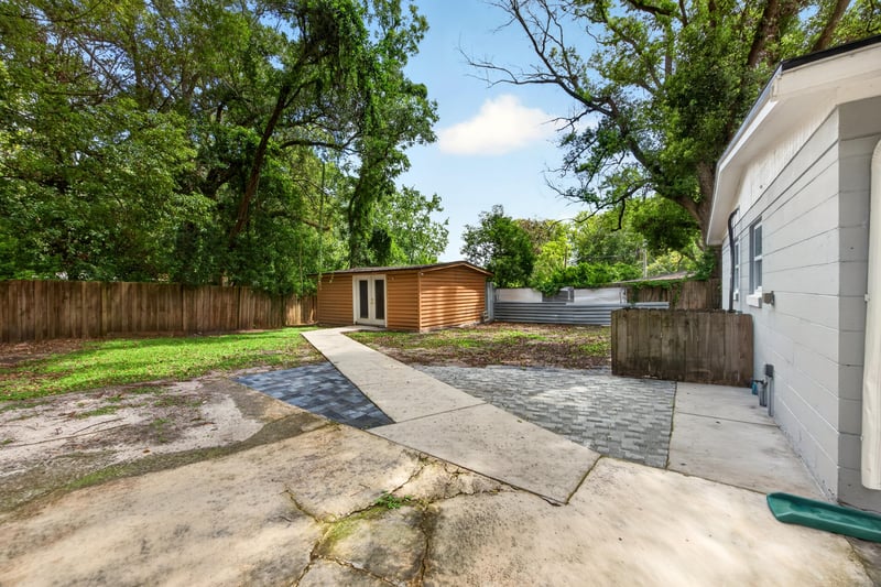 Backyard concrete pad with wood fence at 7015 Miss Muffet Ln N, Jacksonville, FL 32210