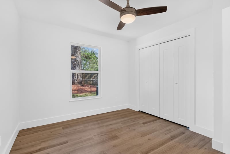 Empty bedroom with closet doors and window at 8453 Boysenberry Ln W, Jacksonville, FL