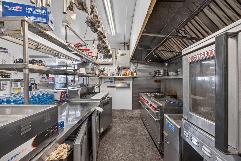 Commercial kitchen with stove range and hood at 115 Cordova St, St. Augustine, FL