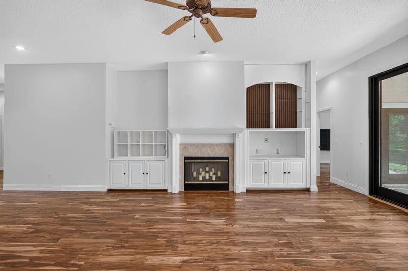 Fireplace with white built-ins and wood floors at 11675 Magnolia Estates Rd, Jacksonville, FL 32223