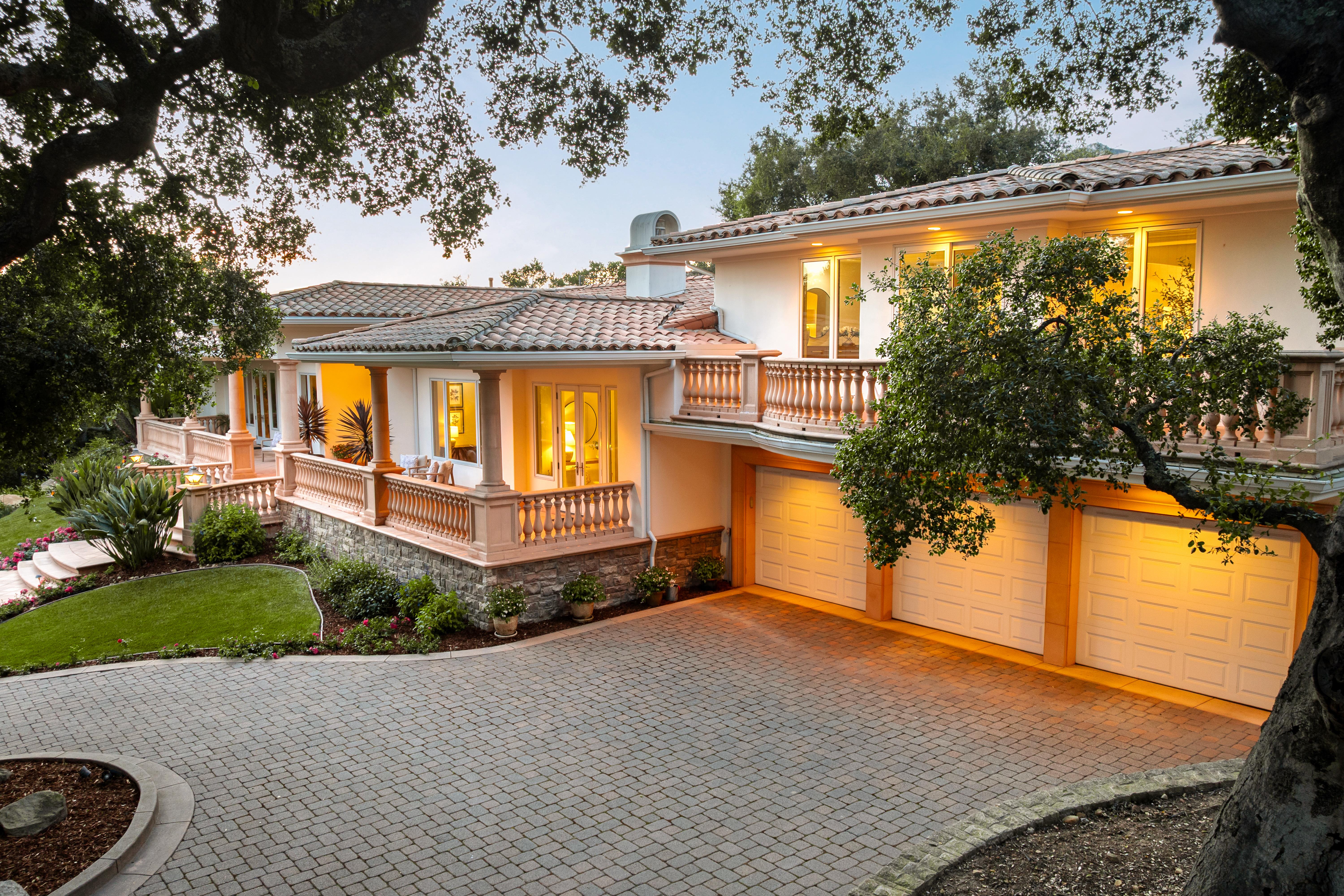 Aerial drone photography of hillside property grounds at 450 El Cielito Rd, Santa Barbara — real estate drone photography documenting terraced outdoor spaces, pool, and Santa Ynez Mountain backdrop along the Southern California coast. Our team captured still photography, aerial drone photography, twilight photography, a Matterport virtual tour, a 2D floor plan, and a custom property website from afternoon through twilight.