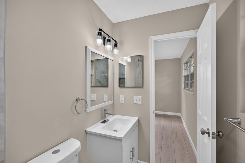 Bathroom vanity with double mirrors at 4117 Wilcrest Ct, Jacksonville, FL 32277