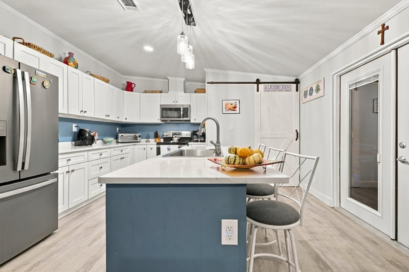 Kitchen island and cabinetry, photographed by Megapixeler on Secret Cove Rd, Middleburg, FL