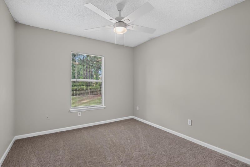 Bedroom corner with window at 12949 Chets Creek Dr S, Jacksonville, FL 32224