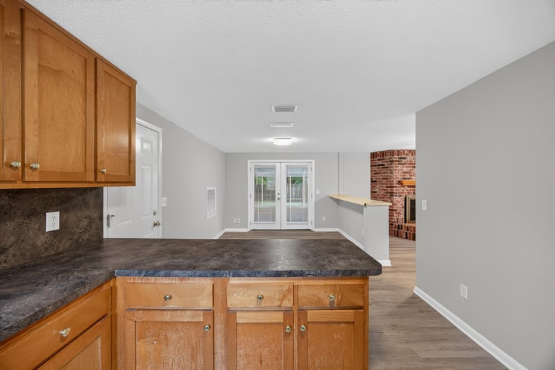 Kitchen counter opening toward living room fireplace at 1435 Undine Ave, Jacksonville, FL