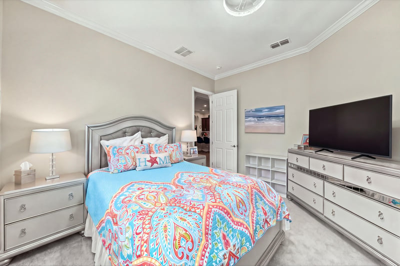Secondary bedroom with colorful bedding, photographed by Megapixeler on Lucena Ln, Jacksonville, FL