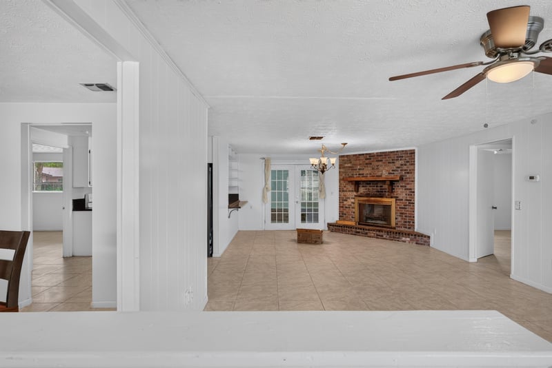 Foyer view into living room with fireplace and ceiling fan at 9954 Larkdale Ct, Jacksonville, FL 32257