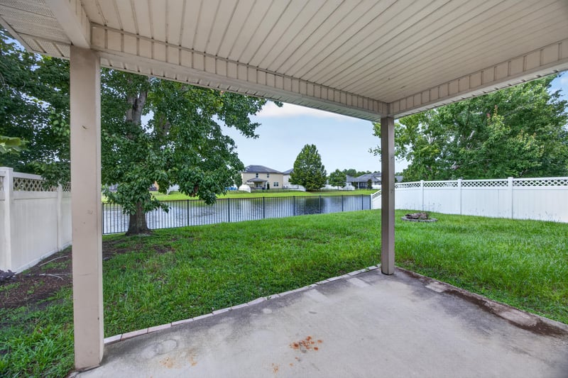 Covered patio with pond view at 469 Glendale Ln, Orange Park, FL