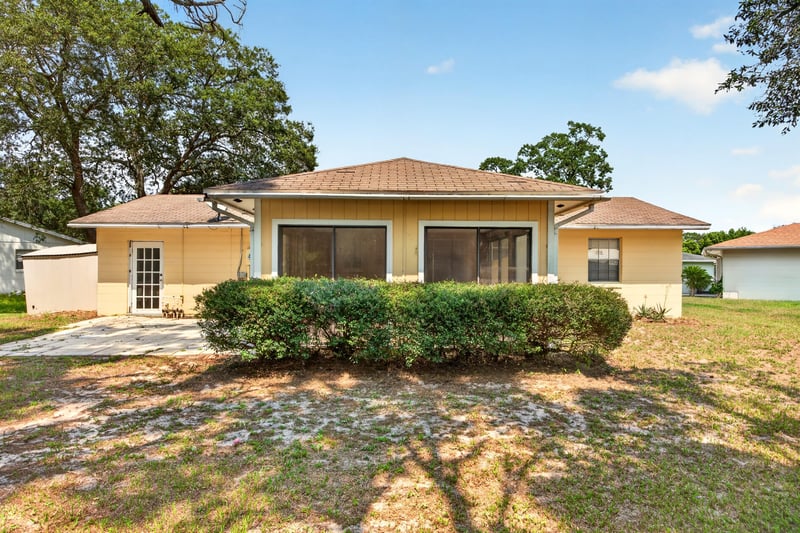 Back exterior with screened porch and yard at 328 Palos Ct, St. Augustine, FL