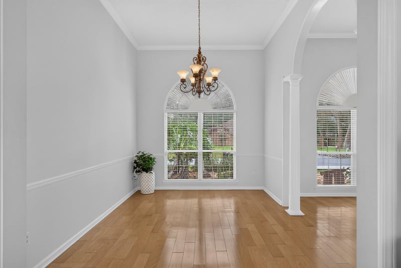 Dining area with windows and wood floors at 12810 Swamp Owl Ln