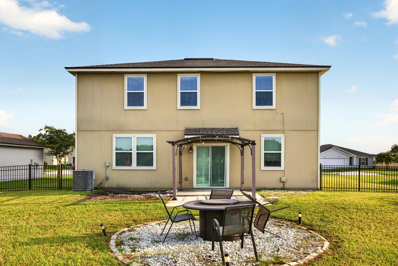 Backyard with pergola, fire pit and fenced lawn at 6830 Hanford St, Jacksonville, FL 32219