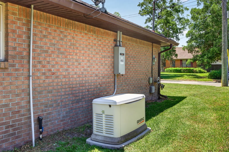 Side exterior with brick wall and backup generator at 2460 San Sago Ln, Jacksonville, FL