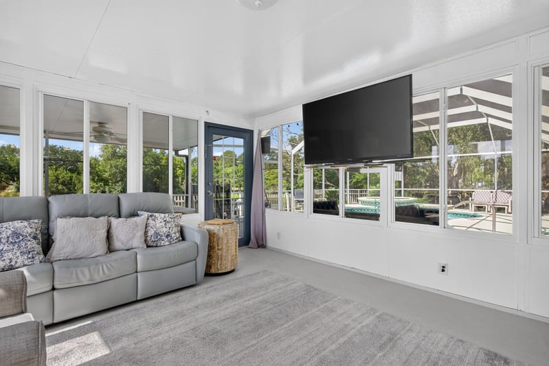 Sunroom with TV and seating at 8680 Bandera Cir S, Jacksonville, FL 32244