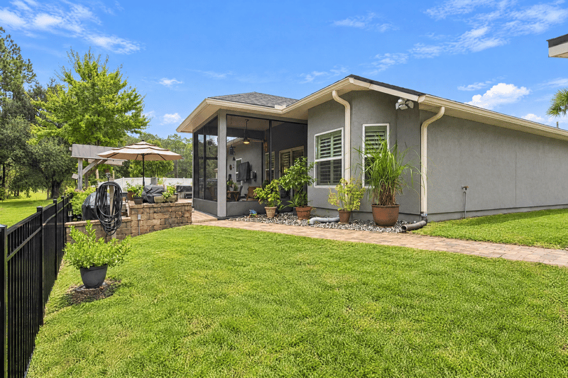 Backyard covered patio and house exterior at 10923 Black Diamond Ct, Jacksonville, FL
