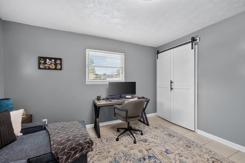 Home office with desk and barn door entry at 6059 Karen St, Jacksonville, FL 32244