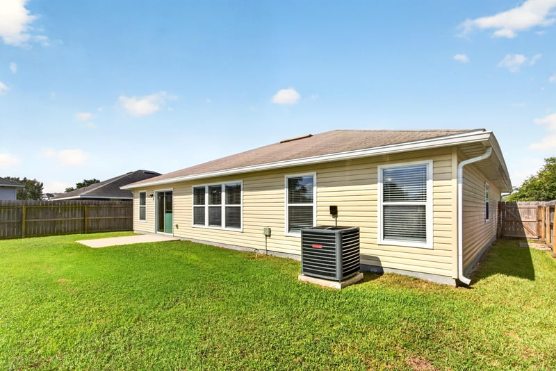 Rear exterior with AC unit and yard at 7545 Lirope St, Jacksonville, FL 32244