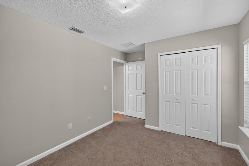 Carpeted bedroom with closet at 14147 Fish Eagle Dr E, Jacksonville, FL 32226