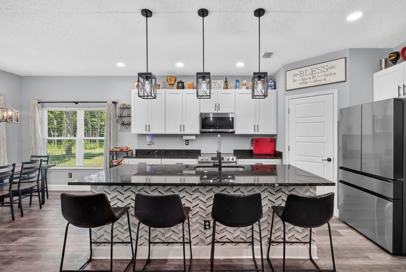 Kitchen with white cabinets and black countertops at 2817 Camel Cir, Middleburg, FL