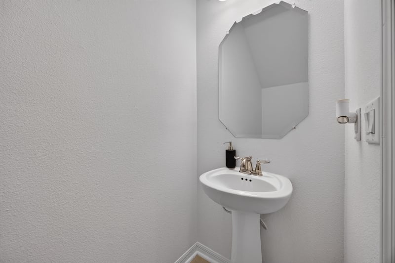Half bathroom with pedestal sink and mirror at 339 Anthony Dr, Jacksonville, FL