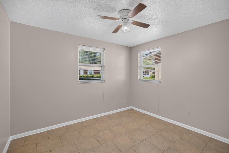 Bedroom with two windows and ceiling fan at 8067 Parental Cir, Jacksonville, FL 32216