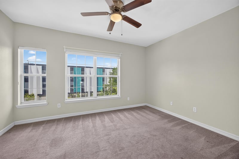 Bedroom with ceiling fan and two windows at 342 E Ashley St, Jacksonville, FL 32202