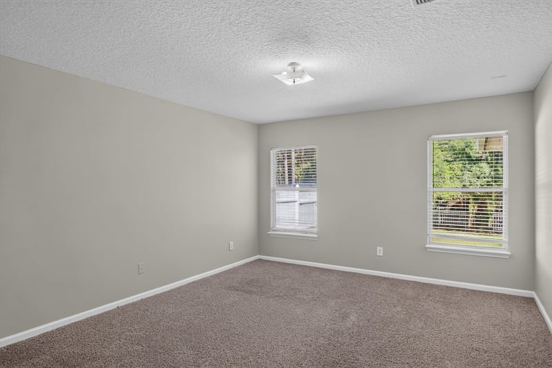 Carpeted bedroom with window at 14147 Fish Eagle Dr E, Jacksonville, FL 32226