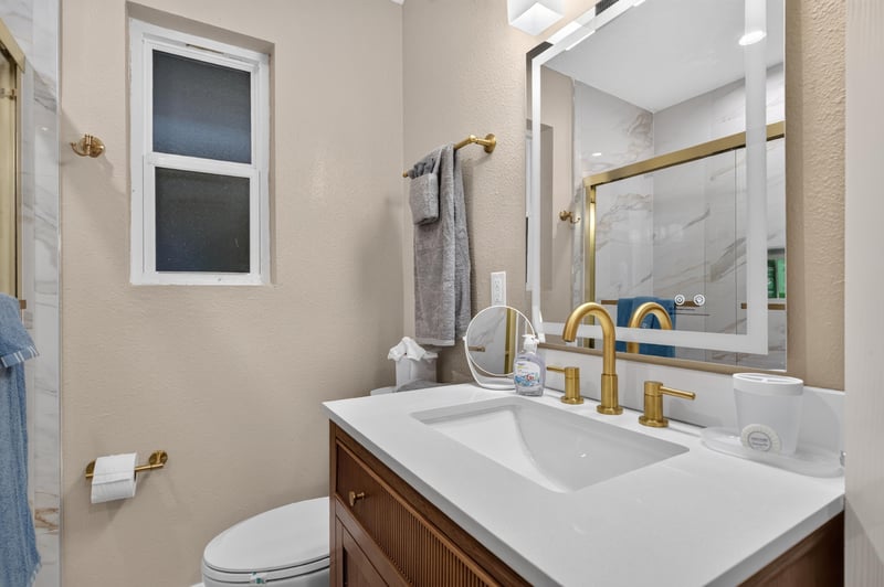 Bathroom with gold fixtures and mirror at 1525 8th St N, Jacksonville Beach, FL