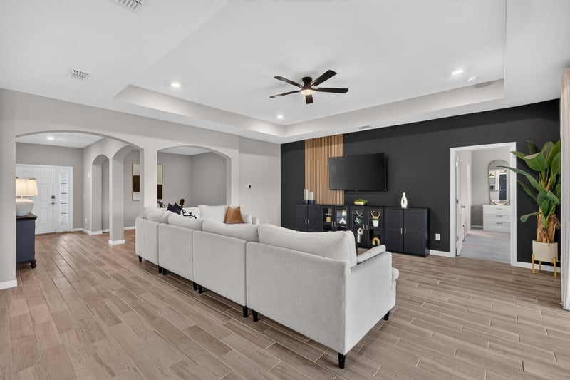 Living room open to foyer with wood-look floors at 9942 Lovage Ln, Jacksonville, FL 32219