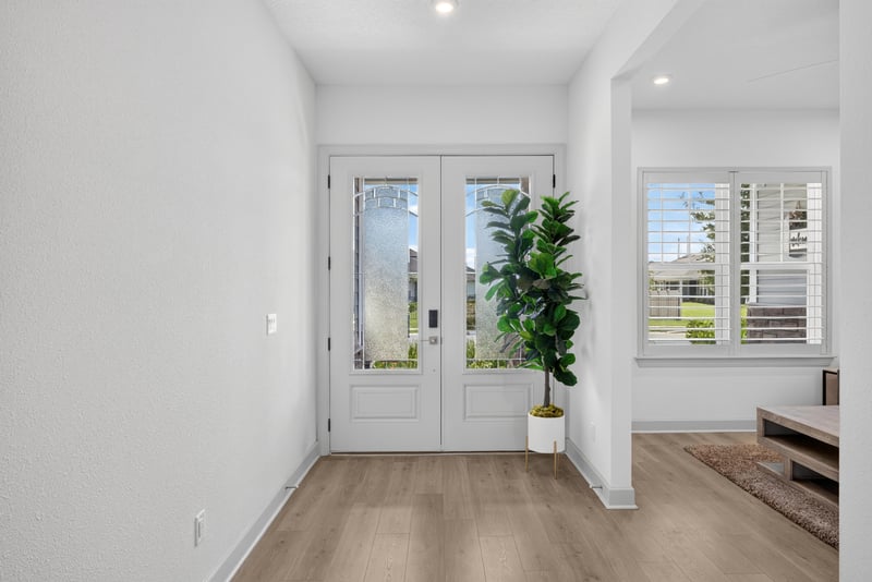 Foyer with glass-paneled doors and wood flooring at 785 Back Creek Dr, St. Augustine, FL 32092