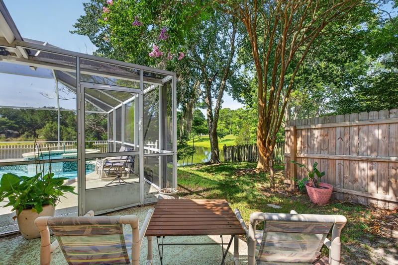 Screened pool area with table seating at 8680 Bandera Cir S, Jacksonville, FL 32244