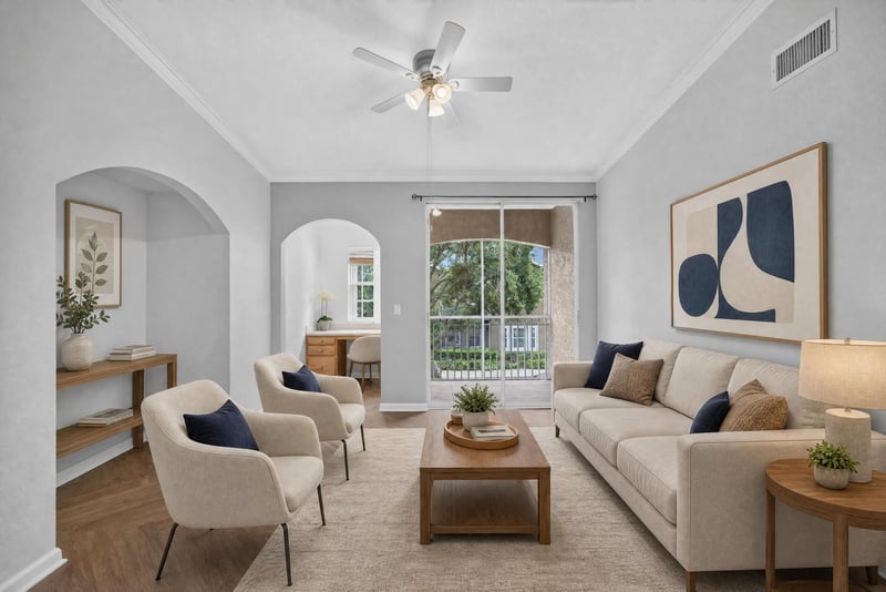 Virtually staged living room with sliding glass door at 10075 Gate Pkwy unit 1905, Jacksonville, FL 32246