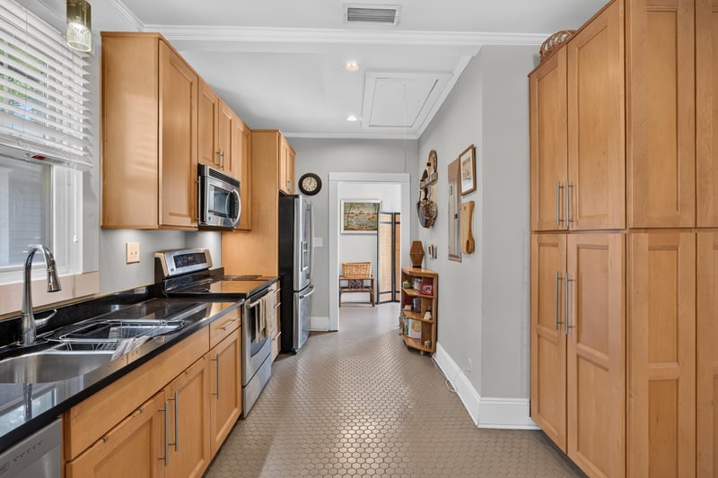 Kitchen with wood cabinets, black countertops and stainless range at 1555 Belmonte Ave, Jacksonville, FL 32207