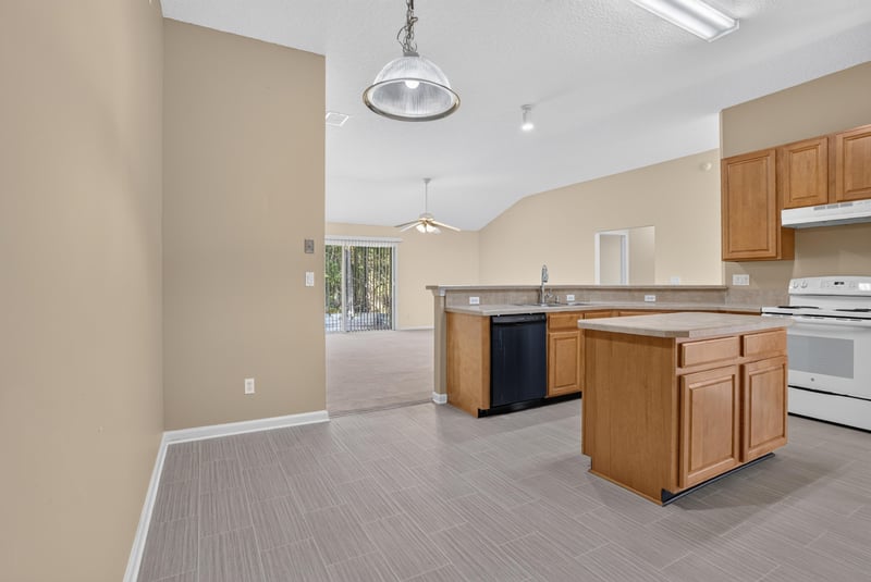 Kitchen island and range viewed from living area at 299 John's Creek Pkwy, St. Augustine, FL 32092
