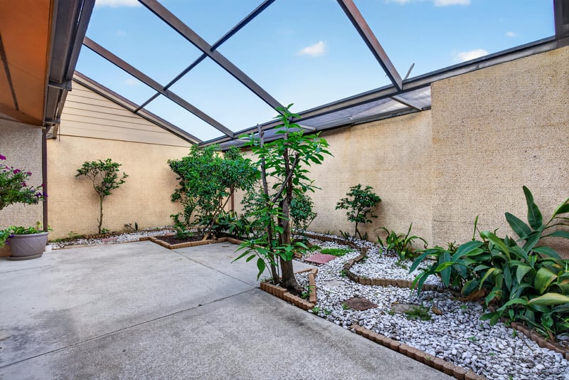 Screened patio with plantings at 3515 Cormorant Branch Ct, Jacksonville, FL