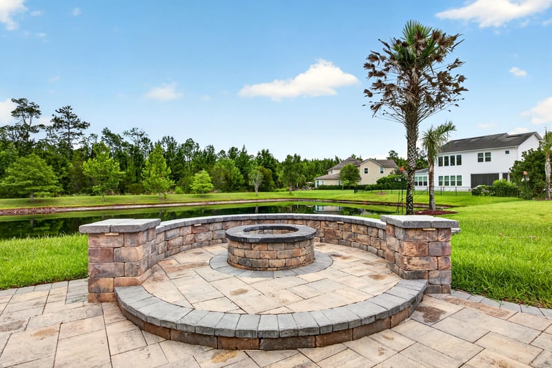 Paver patio fire pit with seating wall at 186 Freshwater Dr