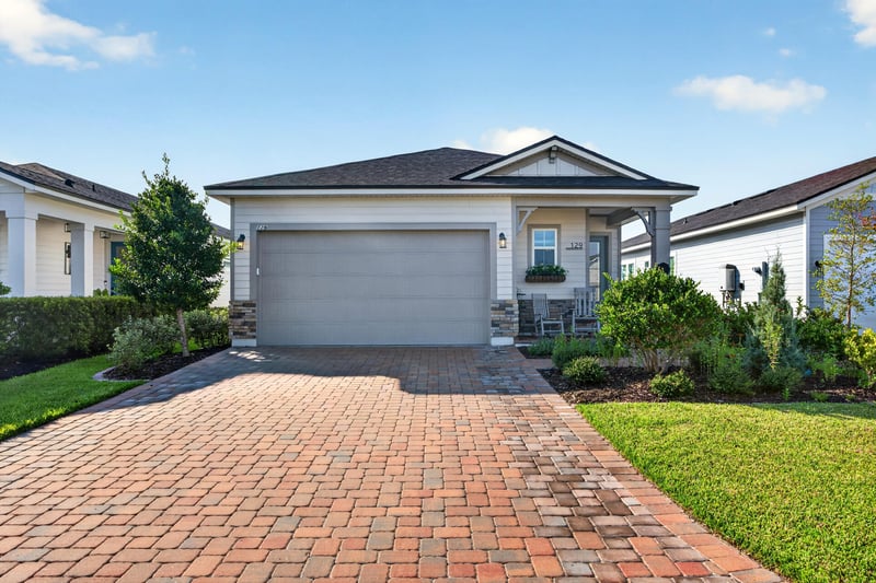 Front exterior with garage and paver driveway at 129 Amberwood Dr, St. Augustine, FL
